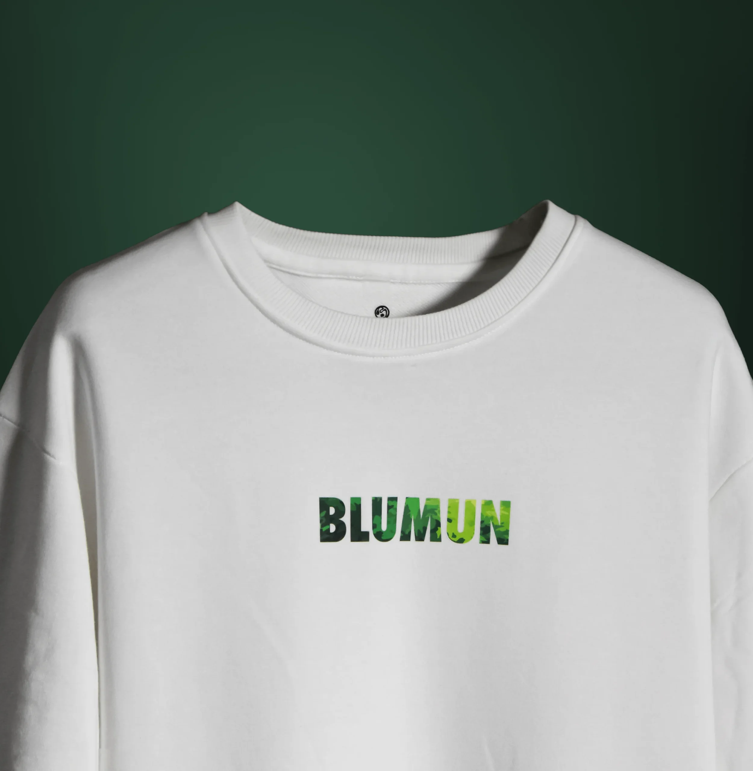 Front view of the Bonsai Tree T-Shirt featuring the word “BLUMUN” in a green, foliage-textured font on a plain white background.