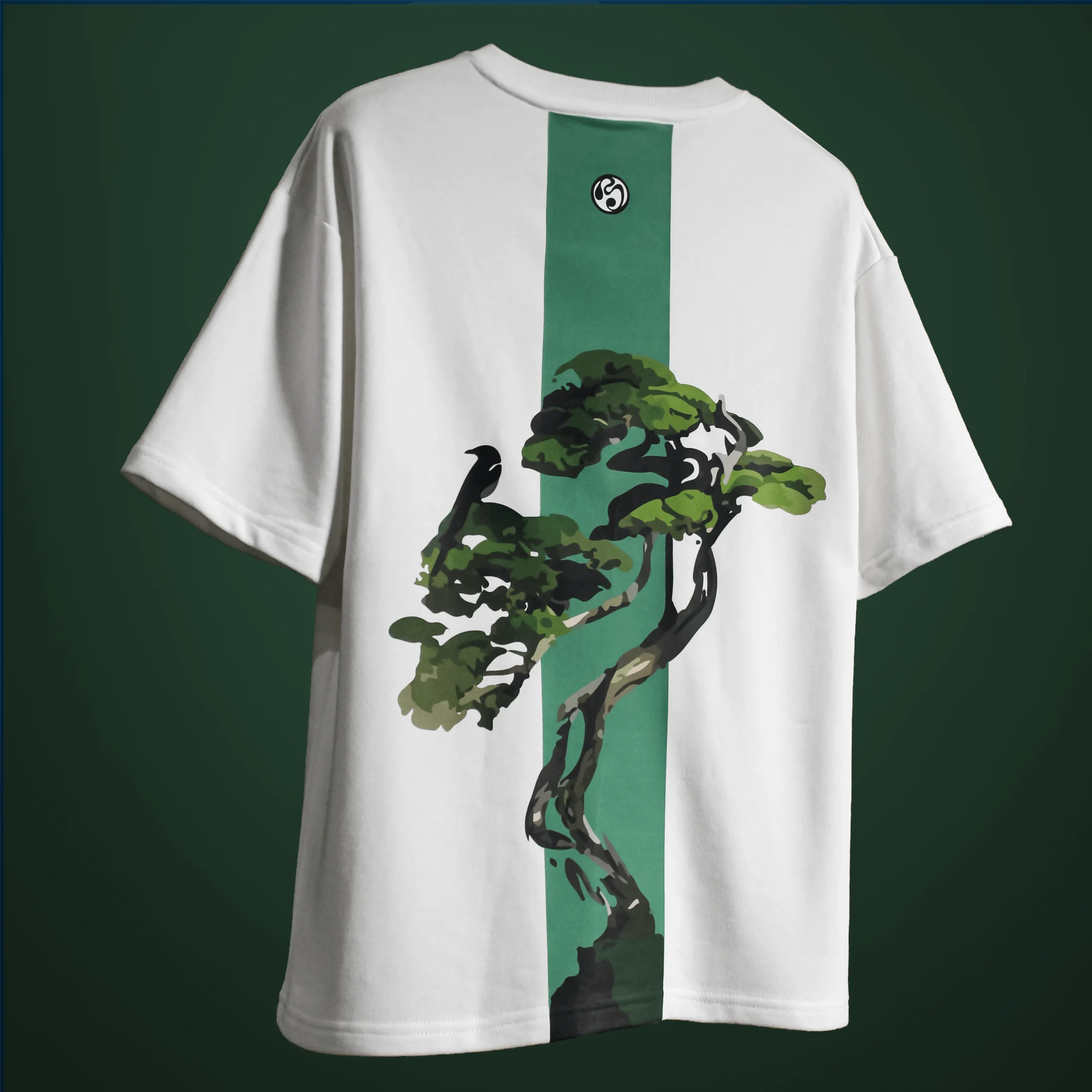 Back view of the Bonsai Tree T-Shirt showing a green vertical stripe with an artistic bonsai tree and crow graphic, printed on white fabric.