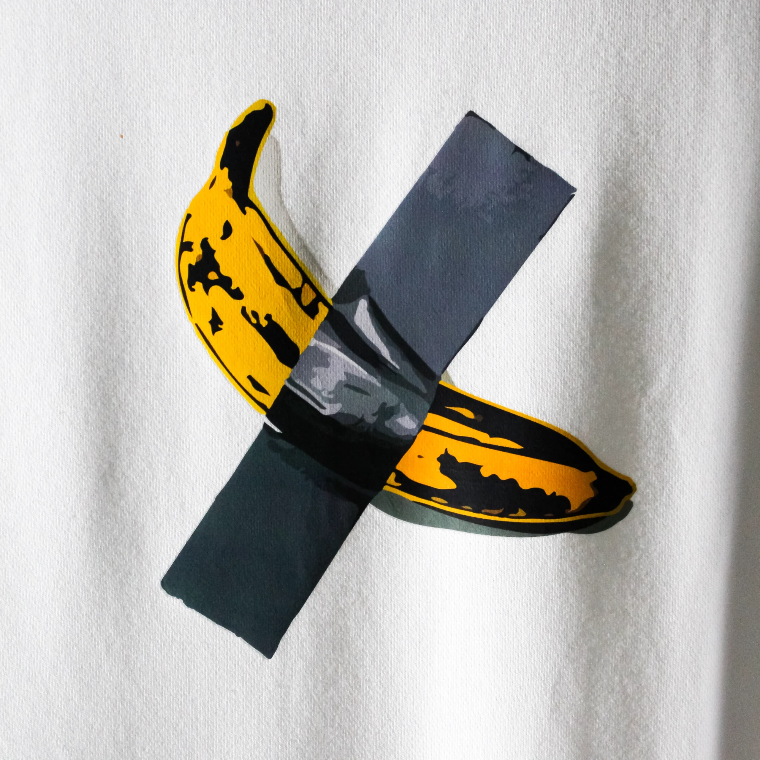 Full view of the $6 Million Banana T-Shirt displayed on a hanger, showing the oversized fit and central banana artwork on a white t-shirt.