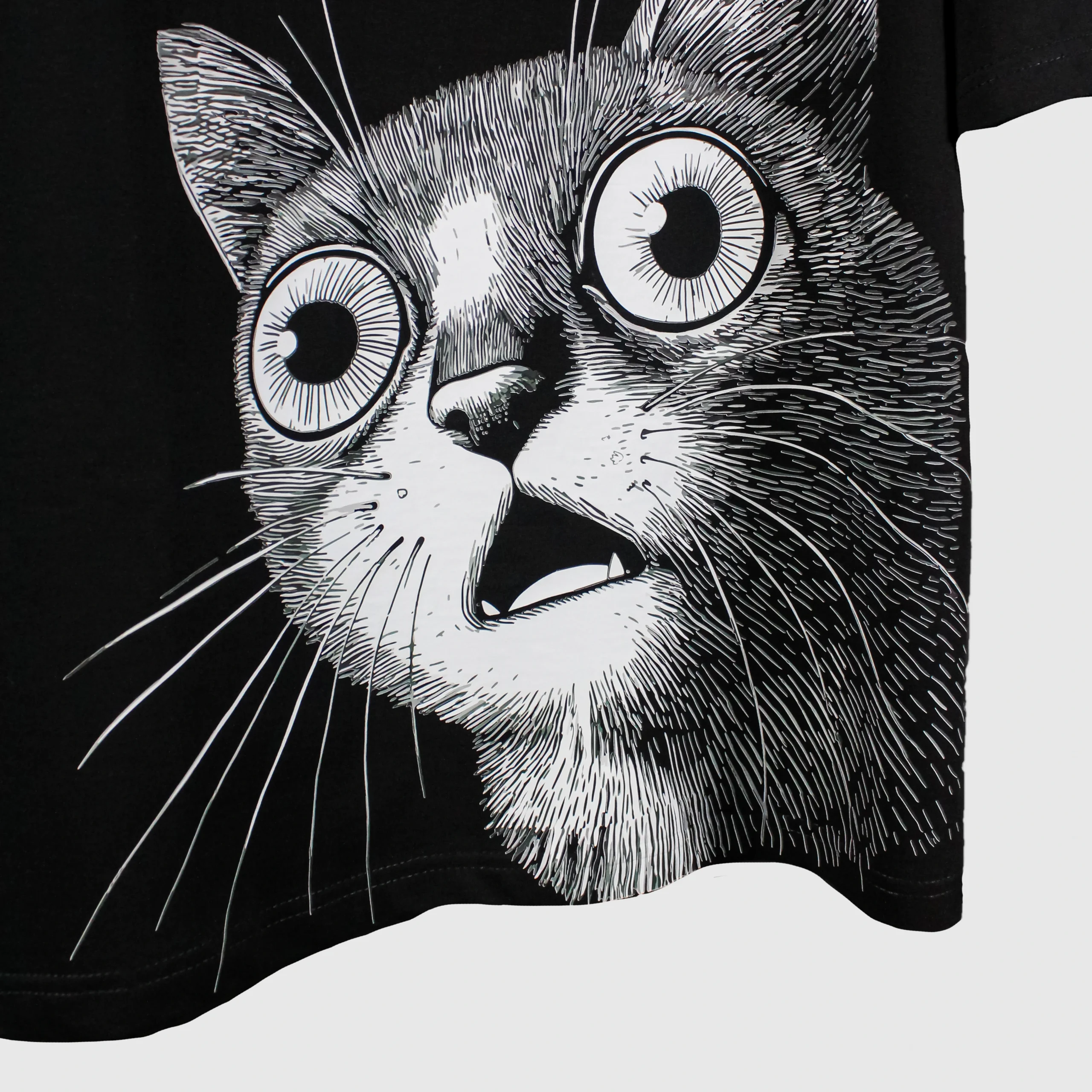 Oversized black t-shirt with white graphic print of surprised cat face – bold streetwear design for cat lovers