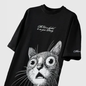 Black oversized streetwear t-shirt with large shocked cat graphic and 'The Cat is shocked to see your Beauty' text on front – bold monochrome illustration with Meow branding on sleeve
